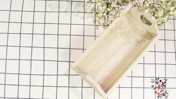 White wooden tray on square cloth and flowers photo