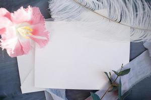 Blank paper copy space. Frame with flowers. Silk ribbon. Gray background. Simple bouquet. Greeting card. photo