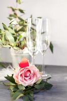 Composition with glass for champagne. Flowers and hearts on grey concrete background. photo