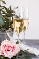 Composition with glasses of vine and flowers on grey concrete background. photo