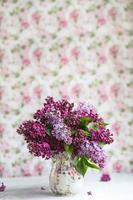 Bouquet of violet lilac in a vase. Still life with blooming branches of lilac in vases. Greeting card mock up. Space for text. photo