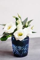 White flowers in classic blue glass. Lisianthus. Eustoma photo