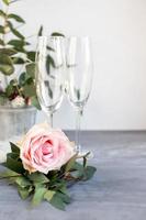 Composition with glass for champagne. Flowers and hearts on grey concrete background. photo