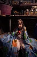 Ukrainian kid takes shelter in her basement. Stop war photo