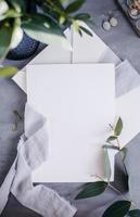 Blank paper copy space. Frame with flowers. Silk ribbon. Gray background. Simple bouquet. Greeting card. photo