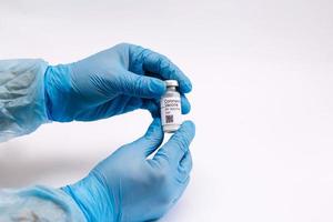 Coronavirus vaccine. Doctor with a vaccine. Hands holding a coronavirus vaccine ampoule, Covid-19 photo