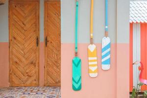 Colorful background of three colorful wooden paddle hung on wall photo