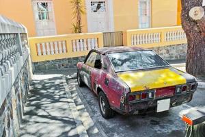 Old dirty rusted car from behind, Bo-Kaap, Cape Town. photo