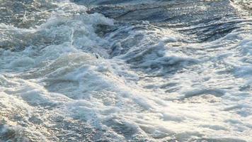 Flowing water stream. A river flows over rocks in the mountains. Waterfall and the rocks in the forest. video