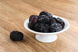 Kurma Ajwa, Ajwa Dates, served in small plate. Kurma Ajwa is one of the special fruit of Arabic. photo