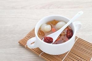 Chinese cuisine, a bowl of peach gum. Peach Gum is Chinese traditional drink that contains peach gum, bird nest, red dates, snow fungus, goji berry, and rock sugar. photo