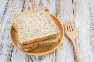 Whole wheat bread on wooden plate