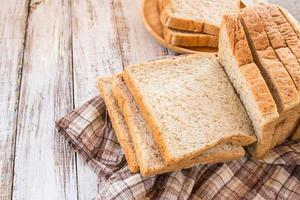 Whole wheat bread on white wooden background