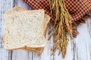 Whole wheat bread on wooden table background