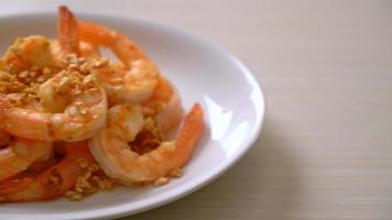 fried shrimps or prawns with garlic on white plate - seafood style video