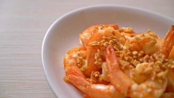 fried shrimps or prawns with garlic on white plate - seafood style video