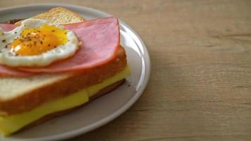 homemade bread toasted cheese topped ham and fried egg with pork sausage for breakfast video