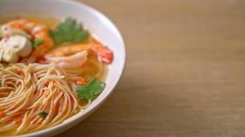 noodles with spicy soup and shrimps in white bowl or Tom Yum Kung - Asian food style video