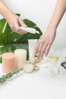 close up hand of applying moisturizing cream, skincare and beauty concept photo