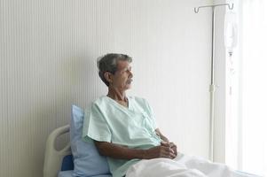 Portrait of senior patient lying on bed in hospital, healthcare and medical concept
