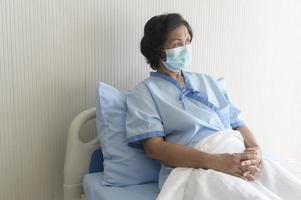 Portrait of senior patient lying on bed in hospital, healthcare and medical concept photo