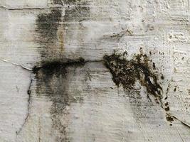 old grunge cement wall background with crack pattern photo