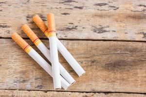 Cigarette roll on old wooden table photo