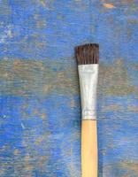 Paint brush on wooden table background.