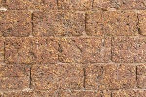 blur of red laterite brick wall Porous and fine-grained Background pattern photo