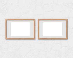 Set of 2 horizontal wooden frames mockup with a border hanging on the wall. Empty base for picture or text. 3D rendering. photo