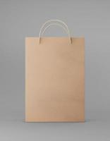 Eco packaging mockup bag kraft paper with handle front side. Standard medium brown template on gray background promotional advertising. 3D rendering photo