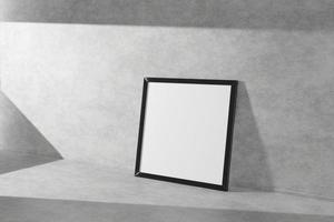 Square mock-up picture frame in black stend on a concrete floor simple interior bright room light and shadow of the window. 3D rendering photo