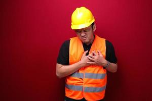 Heart attack or broken heart of young asian man with hurt emotion wear black shirt. photo