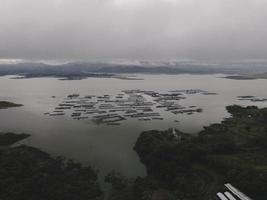 Aerial view of traditional floating fish pond on lake in Indonesia photo