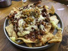 Nachos in a bowl with cheese ready to eat photo