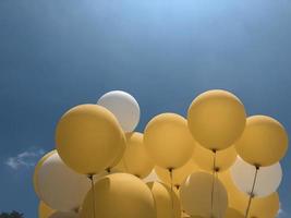 Yellow and white balloon with blue background photo