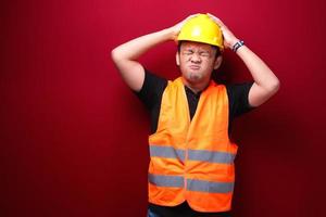 Confused and stress face of Young Asian man worker with hand gesture. Advertising model concept. photo