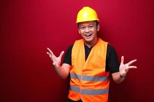 Young Asian Man worker is happy and smiling with open hand gesture photo