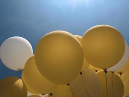 Yellow and white balloon with blue background photo