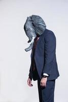 man with an elephant mask on a light background photo