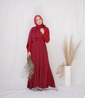 Beautiful islamic female model wearing hijab fashion, a modern lifestyle outfit for muslim woman. Concept a wedding dress, beauty or eidul fitri. A asian girl model wearing hijab on indoor photoshoot photo