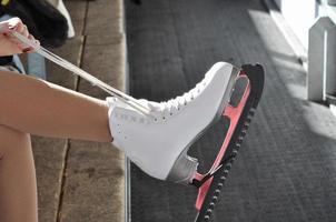 Girl wearing ice skates for ice skating photo