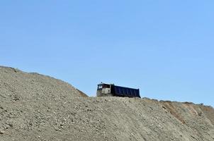 Truck on top of an earth mound photo