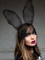 portrait of beautiful stylish fashionable sad woman in bunny lace ears photo