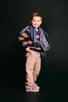 portrait of stylish cute little boy in photo studio