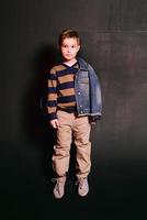 portrait of stylish cute little boy in photo studio