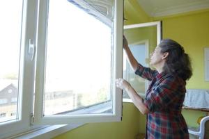 Forty Eight Year Old Woman Washing the Windows photo