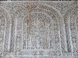 Close up detail of filigree walls, arches. Detailed handcraft of Moorish Architecture. Travel in time and discover history. Historic destination. Beautiful background and textures. photo