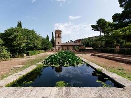 Granada, Spain, 31.08.2021. Upper Alhambra. Reflection in the water. Moorish Architecture. Unesco Unesco World Heritage Spain. Travel in time and discover history. Historical and cultural destination. photo