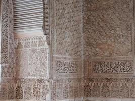 Close up detail of filigree walls, arches. Detailed handcraft of Moorish Architecture. Travel in time and discover history. Historic destination. Beautiful background and textures. photo